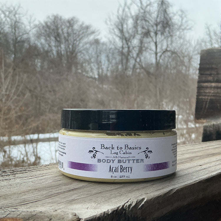 Jar of body butter labeled 'Back to Basics' on a wooden surface with a natural background