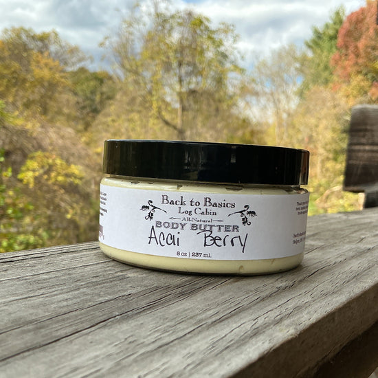 Jar of body butter labeled 'Back to Basics' on a wooden surface with a natural background