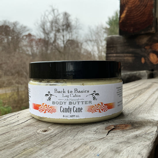 Jar of body butter labeled 'Back to Basics' on a wooden surface with a natural background