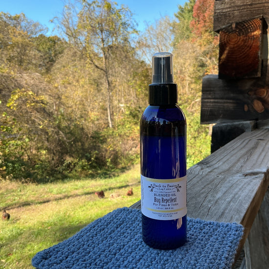 Blue spray bottle with a label on a wooden surface outdoors