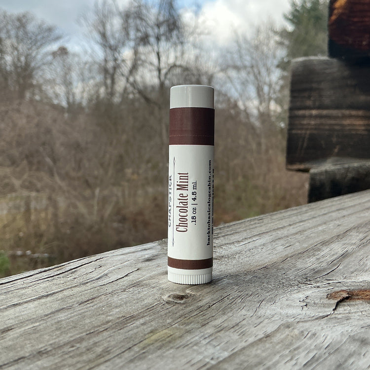 Lip balm tube on a wooden surface with a natural background