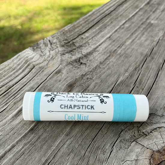 Chapstick stick on a wooden surface with 'Long Cabin' branding