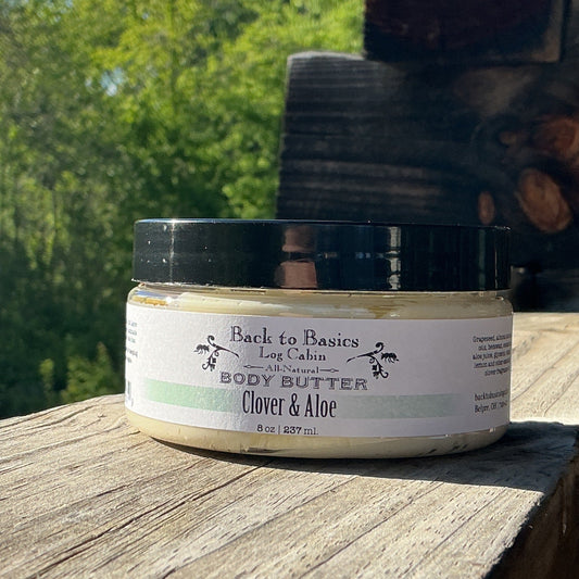 Jar of body butter on a wooden surface with a natural background