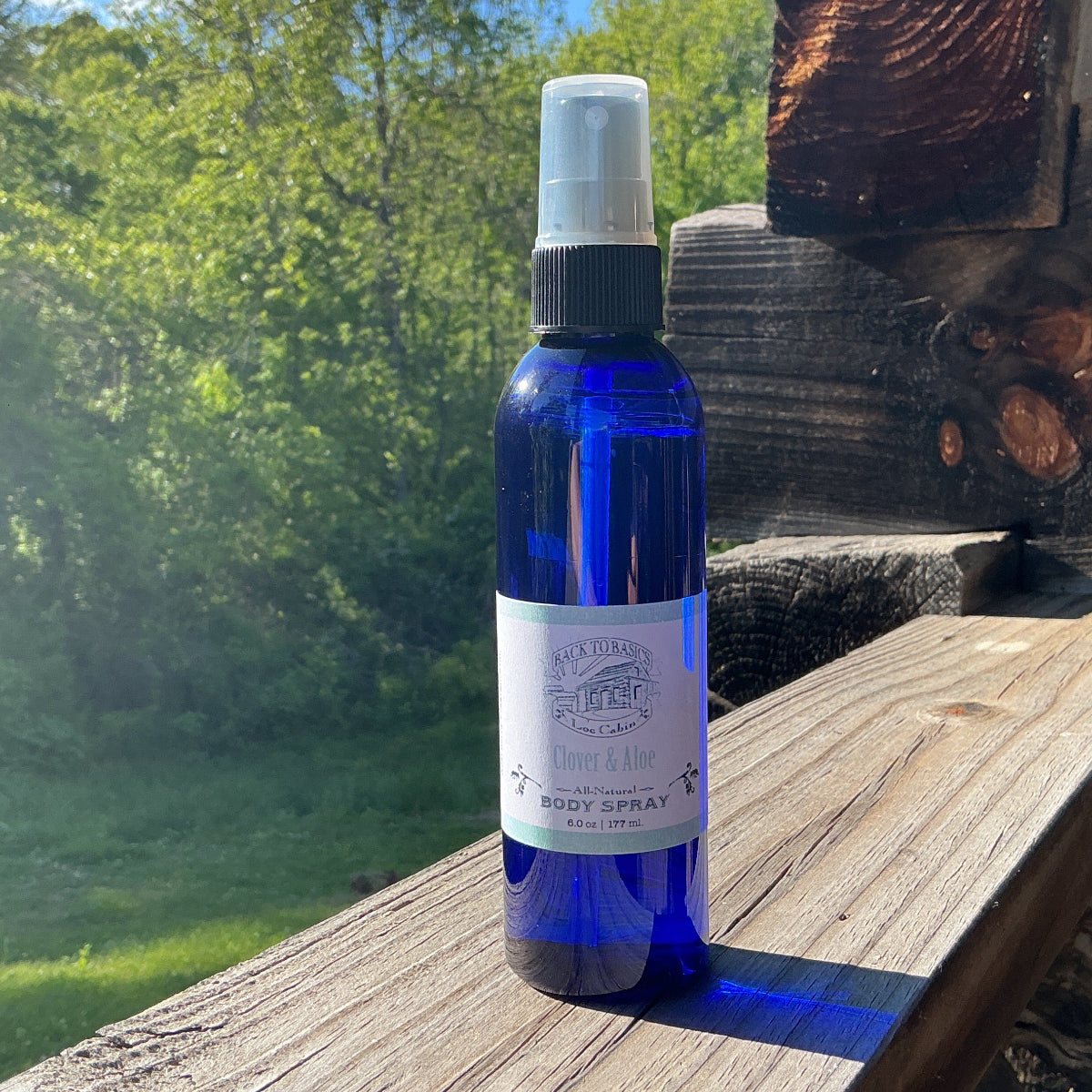 Blue spray bottle on a wooden surface with a natural background