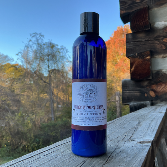 Blue bottle of body lotion on a wooden surface with a natural background