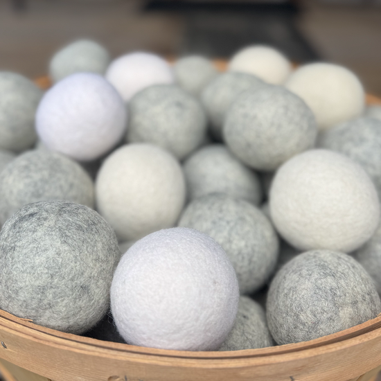 Basket filled with gray and white wool dryer balls