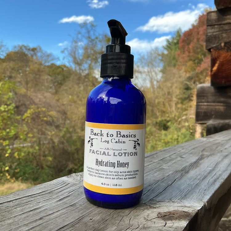 Facial lotion bottle labeled 'Back to the Log Cabin' on a wooden surface with a natural background