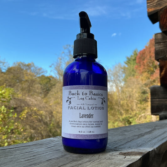 Blue bottle of Back to Basics Lavender Facial Lotion on a wooden surface with a natural background