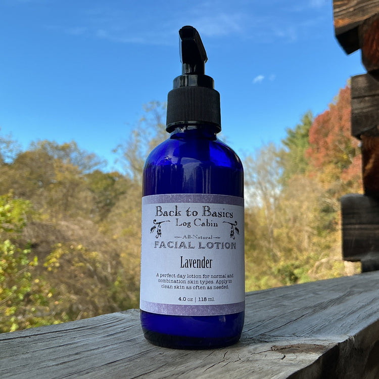 Blue bottle of Back to Basics Lavender Facial Lotion on a wooden surface with a natural background