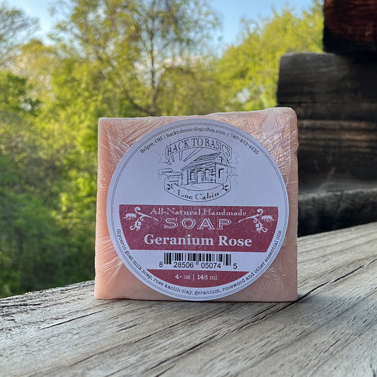 Bar of soap with a label on a wooden surface outdoors