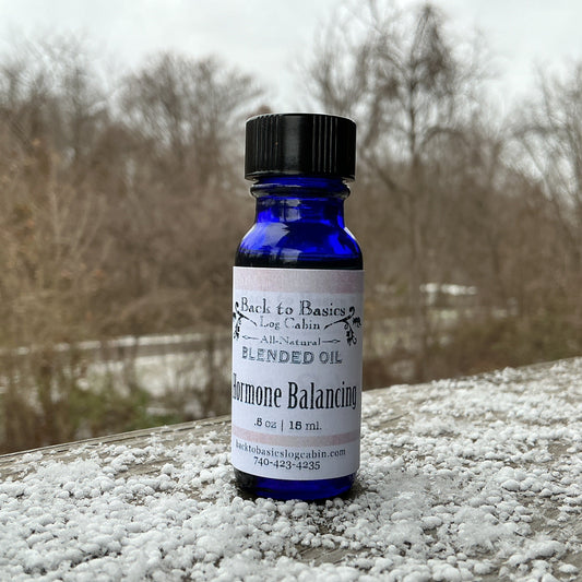 Bottle of Blended Oil on a snowy surface with a blurred natural background