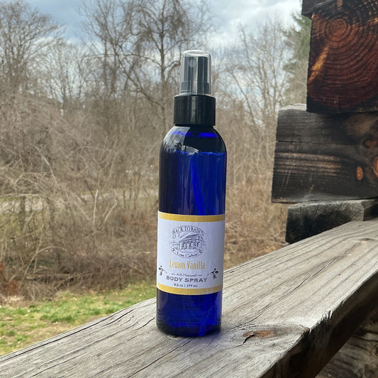 Blue spray bottle on a wooden surface with a natural background