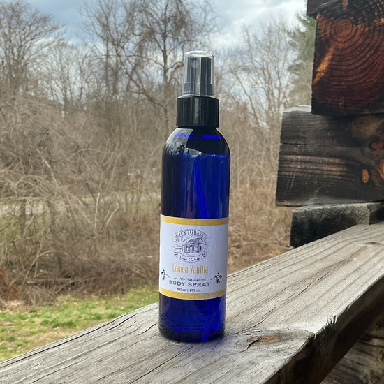Blue spray bottle on a wooden surface with a natural background