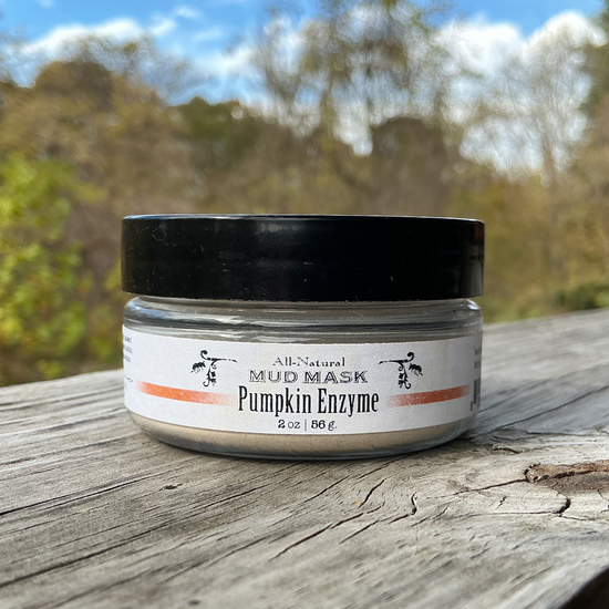Jar of pumpkin enzyme mask on a wooden surface with a natural background