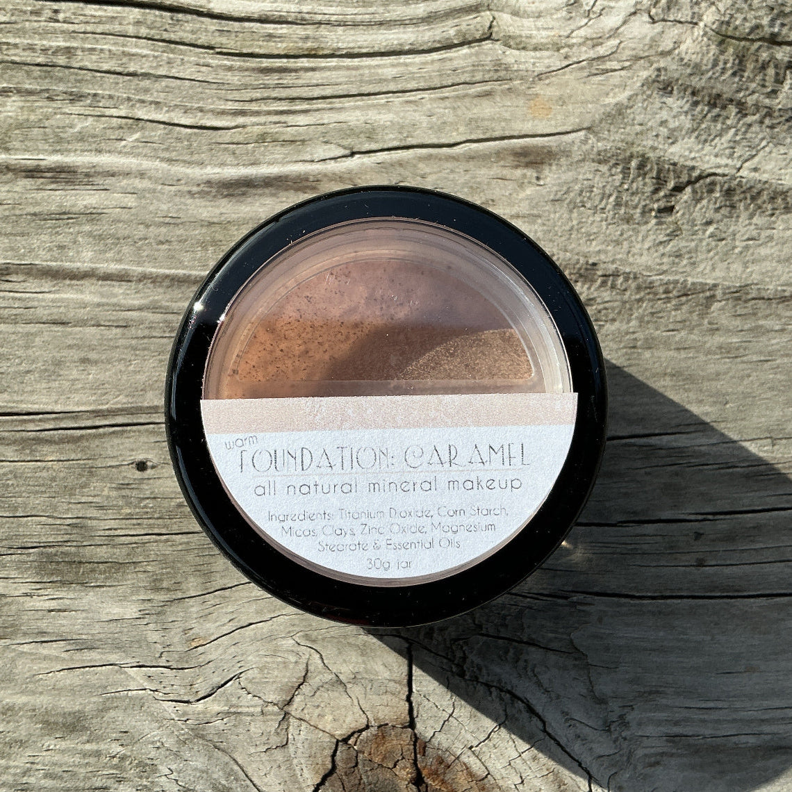 Makeup compact on a wooden surface