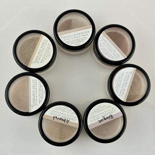 Set of eight black containers with white labels arranged in a circular pattern on a light gray background.