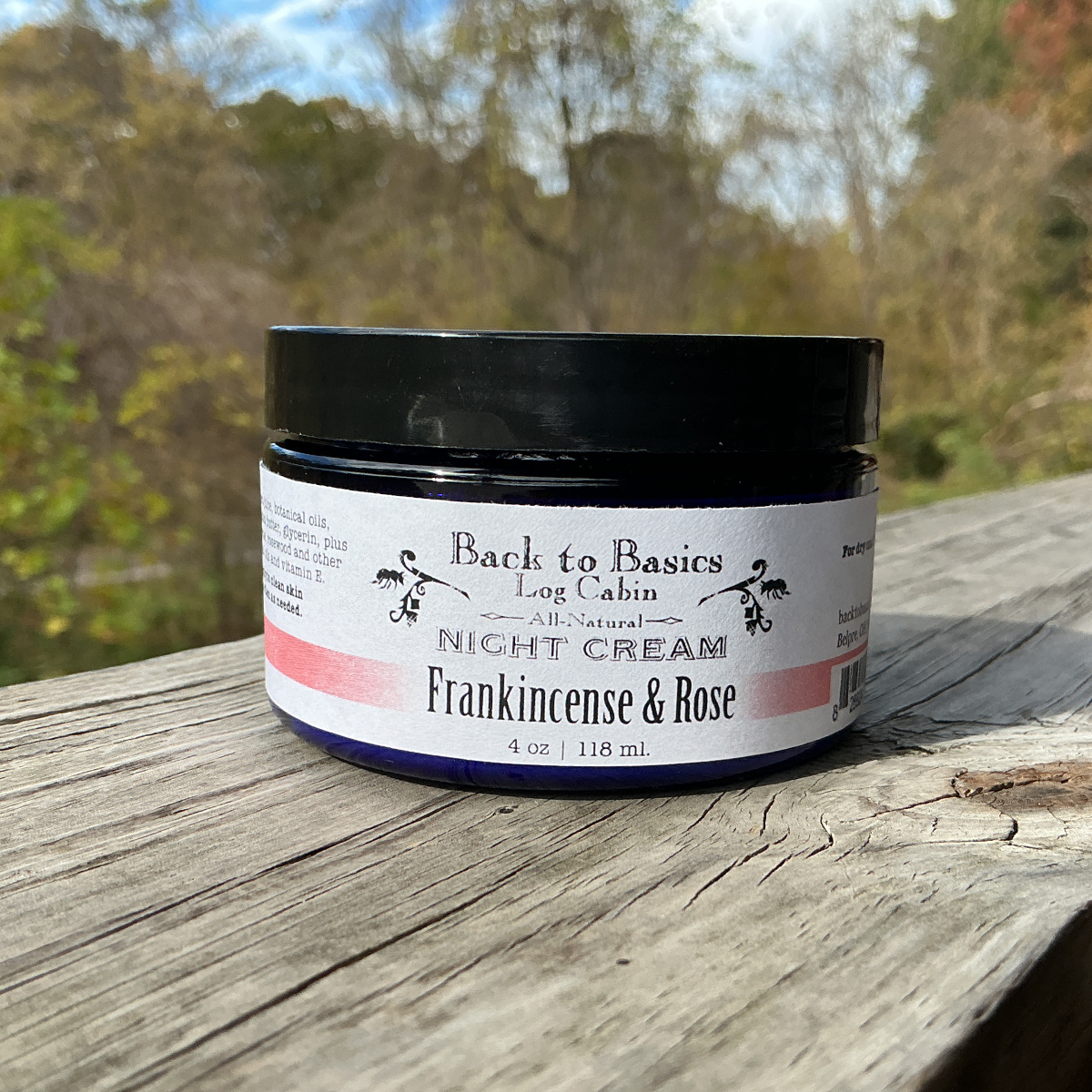 Jar of night cream labeled 'Back to Basics' on a wooden surface with a natural background