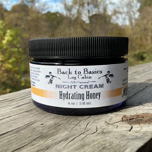 Jar of 'Back to Basics Log Cabin' night cream on a wooden surface with a natural background