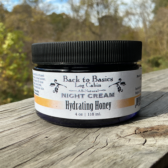 Jar of 'Back to Basics Log Cabin' night cream on a wooden surface with a natural background