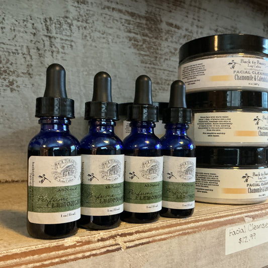 Bottles and jars with labels on a wooden shelf against a textured wall.