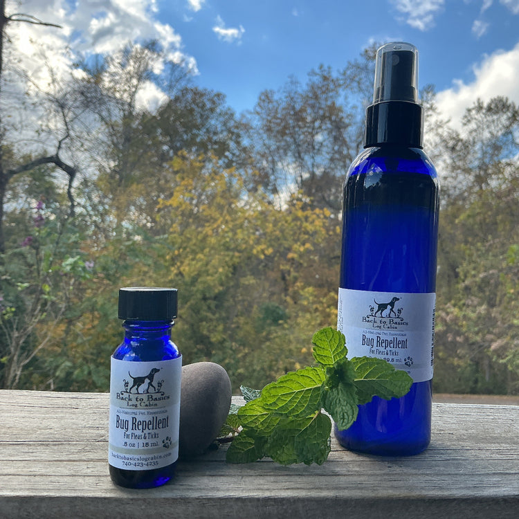 Two blue bottles with labels on a wooden surface outdoors