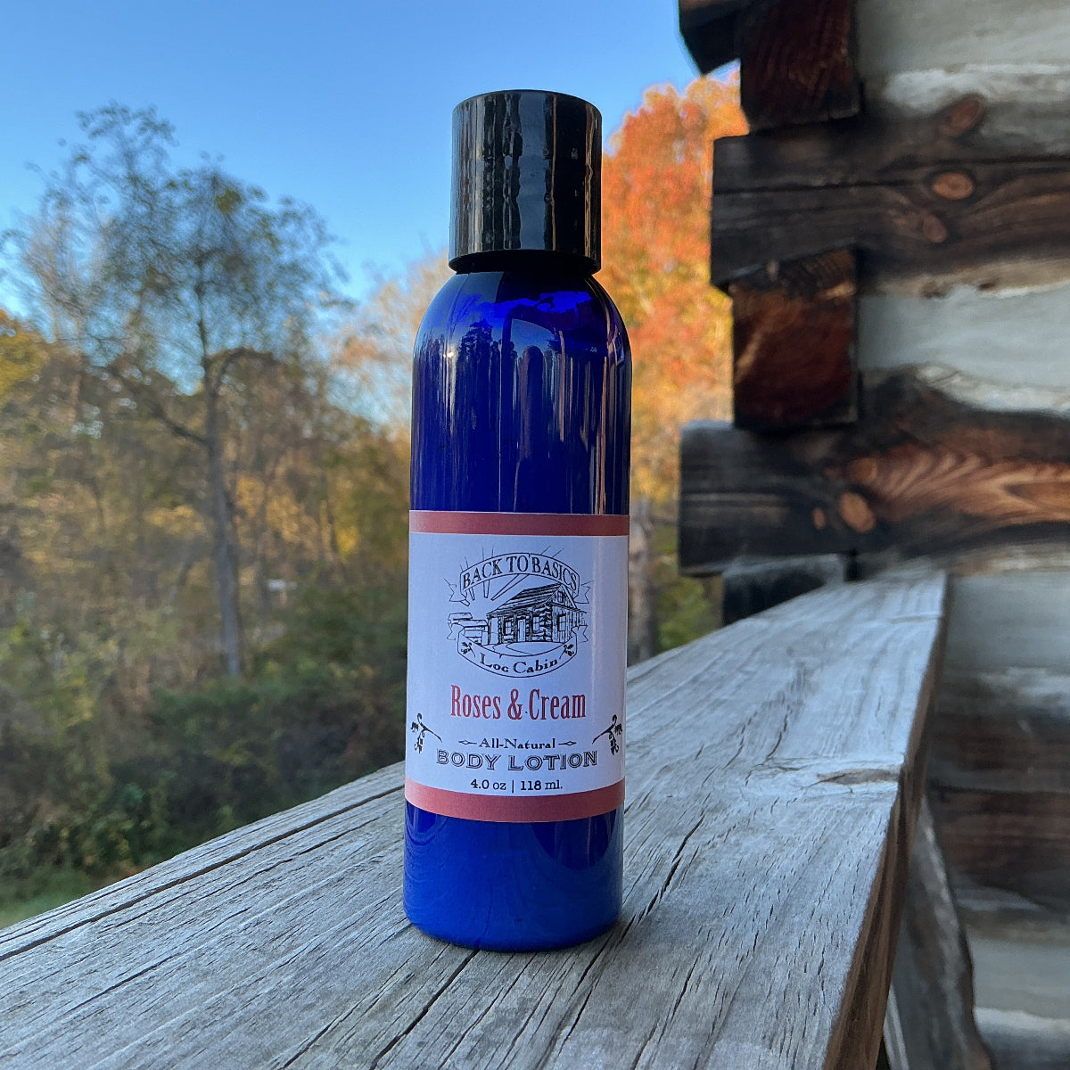 Blue bottle with a label on a wooden surface outdoors