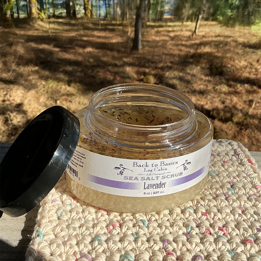 Jar of lavender sea salt scrub on a textured surface with a blurred natural background