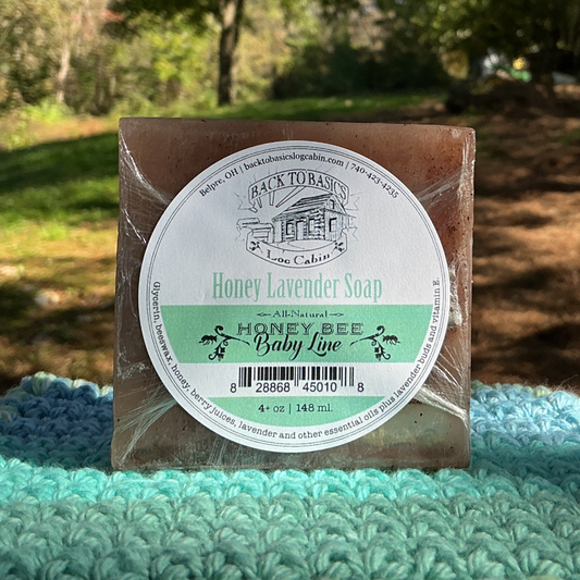 Bar of soap with a label on a green knitted blanket outdoors