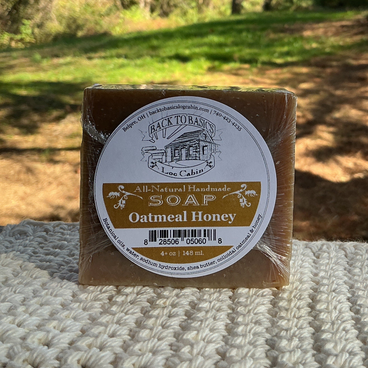 Bar of soap with a label on a textured surface outdoors