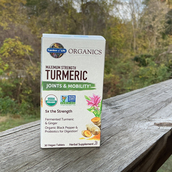 Box of Garden of Life Organics Turmeric supplement on a wooden surface with a natural background